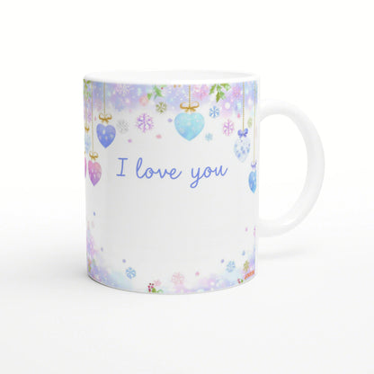 White mug mockup adorned with pastel hanging hearts and snowflakes; blue I love you text across the front.