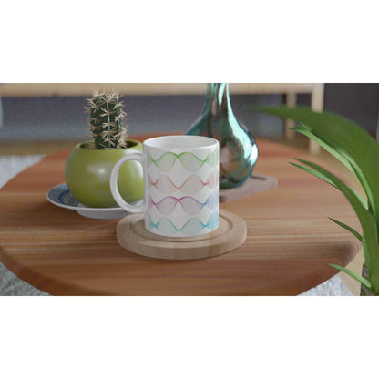 Product mockup: white mug with pastel multicolor wave pattern on a wooden table, with a cactus and a green vase in the background.