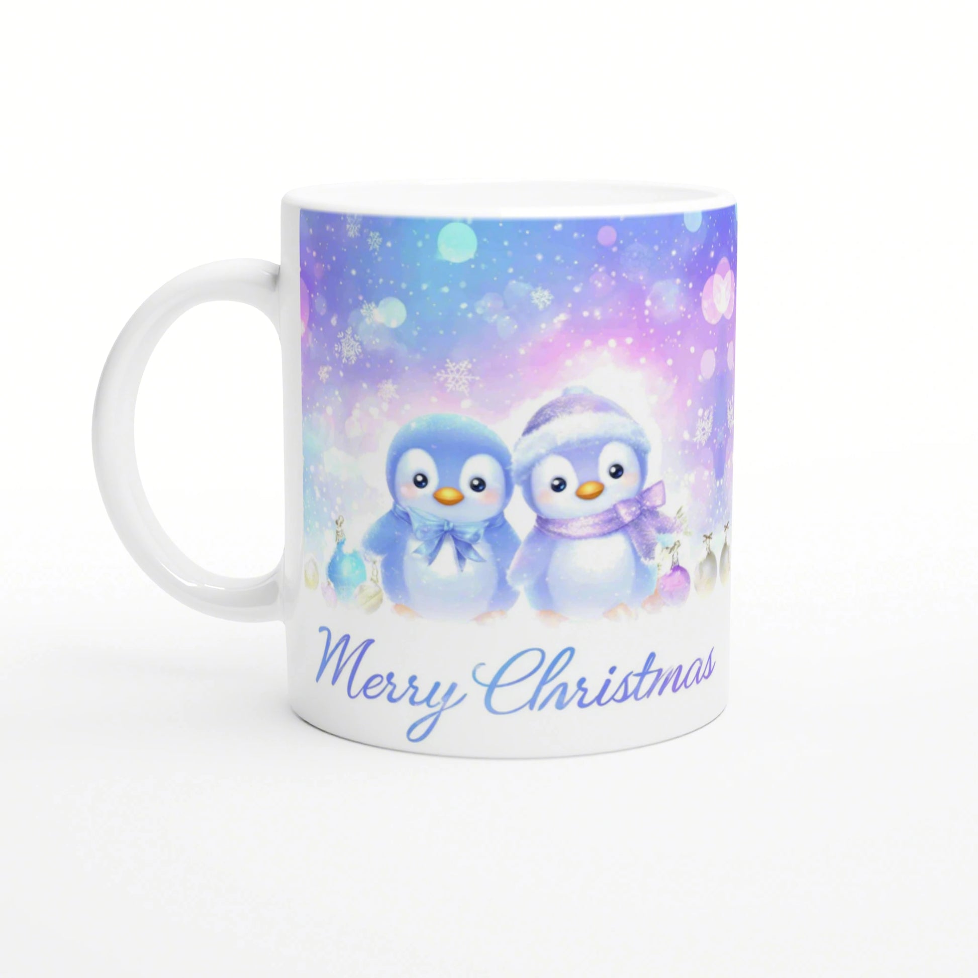 White mug with pastel winter scene, two penguins, snowflakes, ornaments, and Merry Christmas text.
