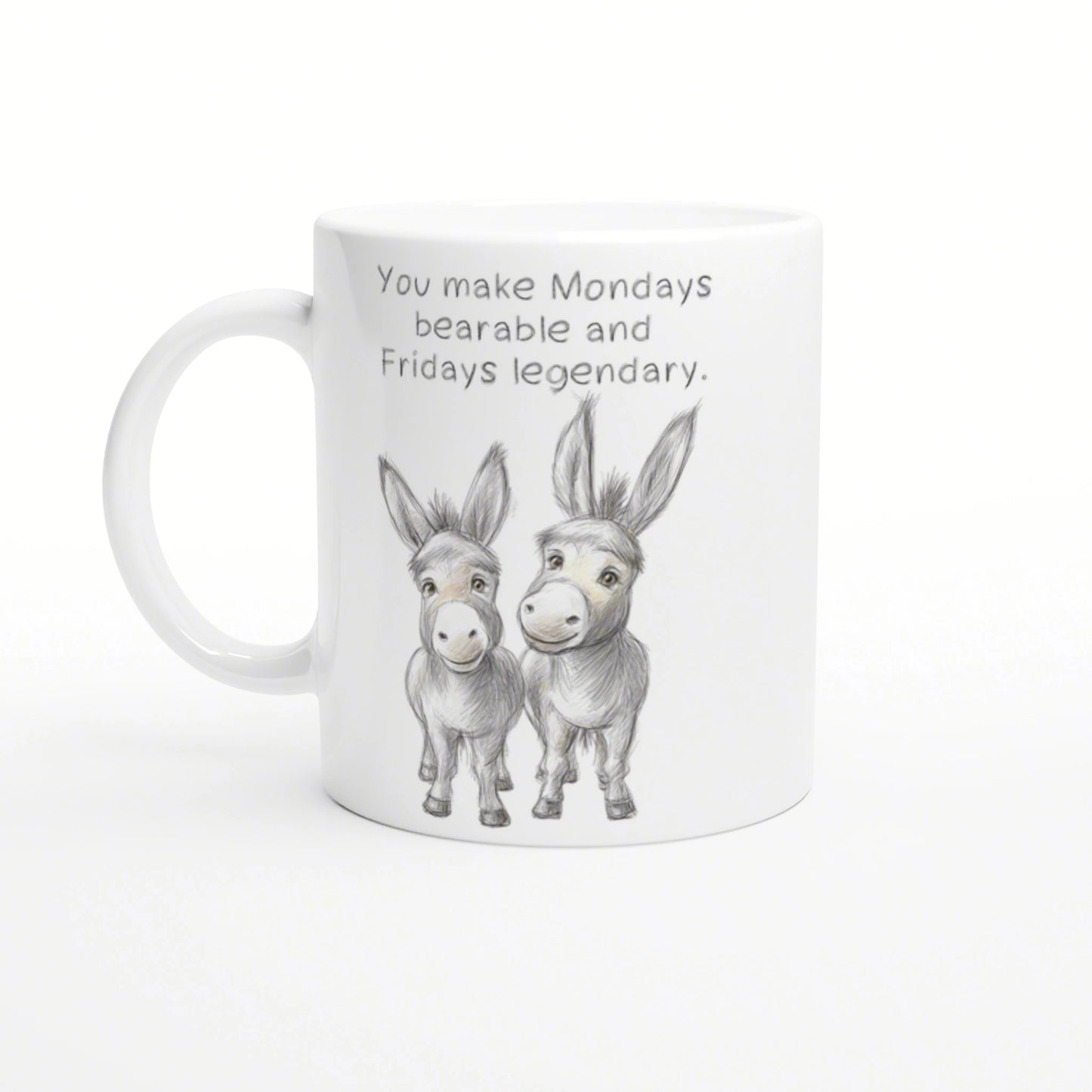 White mug with a pencil sketch of two donkeys and the phrase 'You make Mondays bearable and Fridays legendary'.