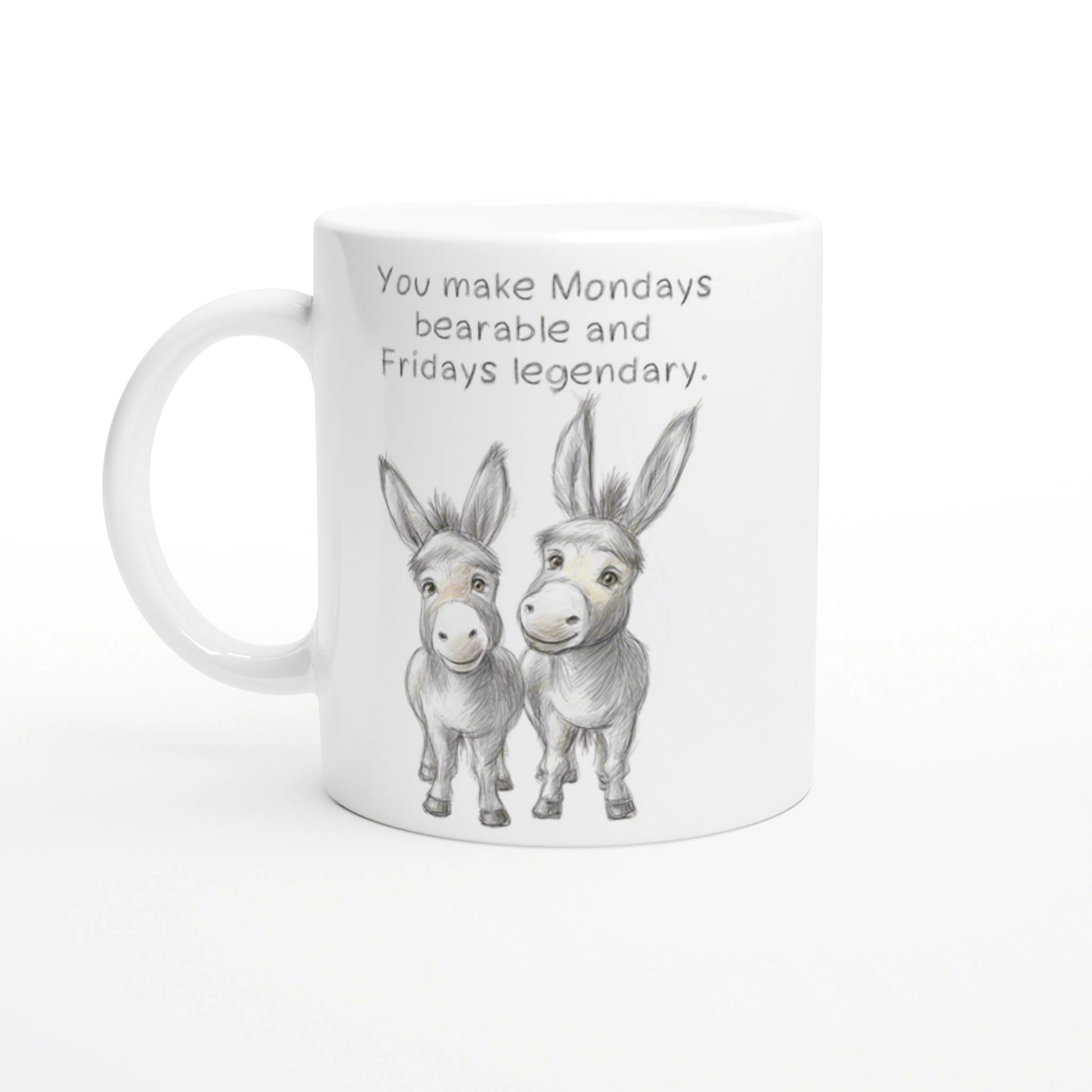 White mug with a pencil sketch of two donkeys and the phrase 'You make Mondays bearable and Fridays legendary'.
