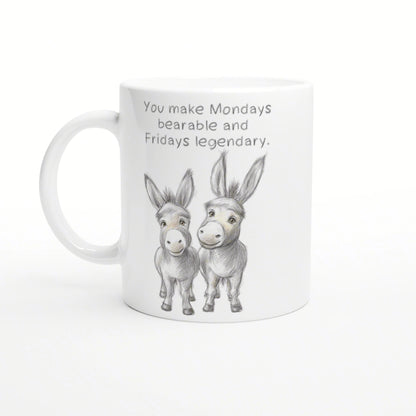 White mug with a pencil sketch of two donkeys and the phrase 'You make Mondays bearable and Fridays legendary'.