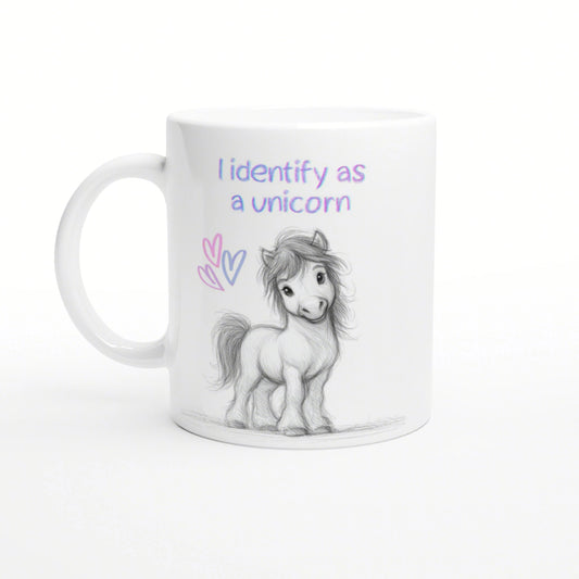 White mug mockup featuring a pencil-drawn pony, pastel hearts, and the slogan 'I identify as a unicorn'.