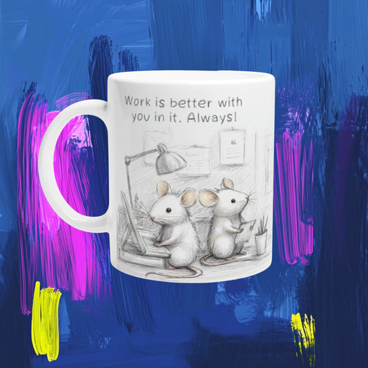 White mug with a pencil sketch of two mice at a desk and the slogan 'Work is better with you in it. Always!' on a colorful background.