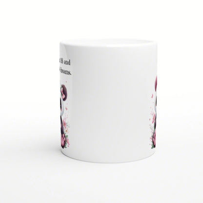 White ceramic mug mockup with pink floral border along the sides and partial text reading '... and dreams'.