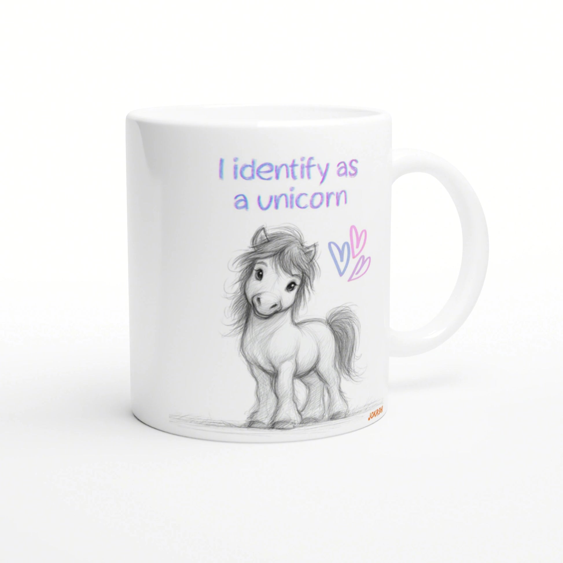White mug with a pencil sketch of a pony and the pastel phrase I identify as a unicorn, plus pink and purple hearts.