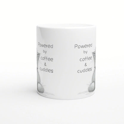 White ceramic mug mockup featuring the phrase 'Powered by coffee & cuddles' in a playful handwritten font, with subtle sketch accents.