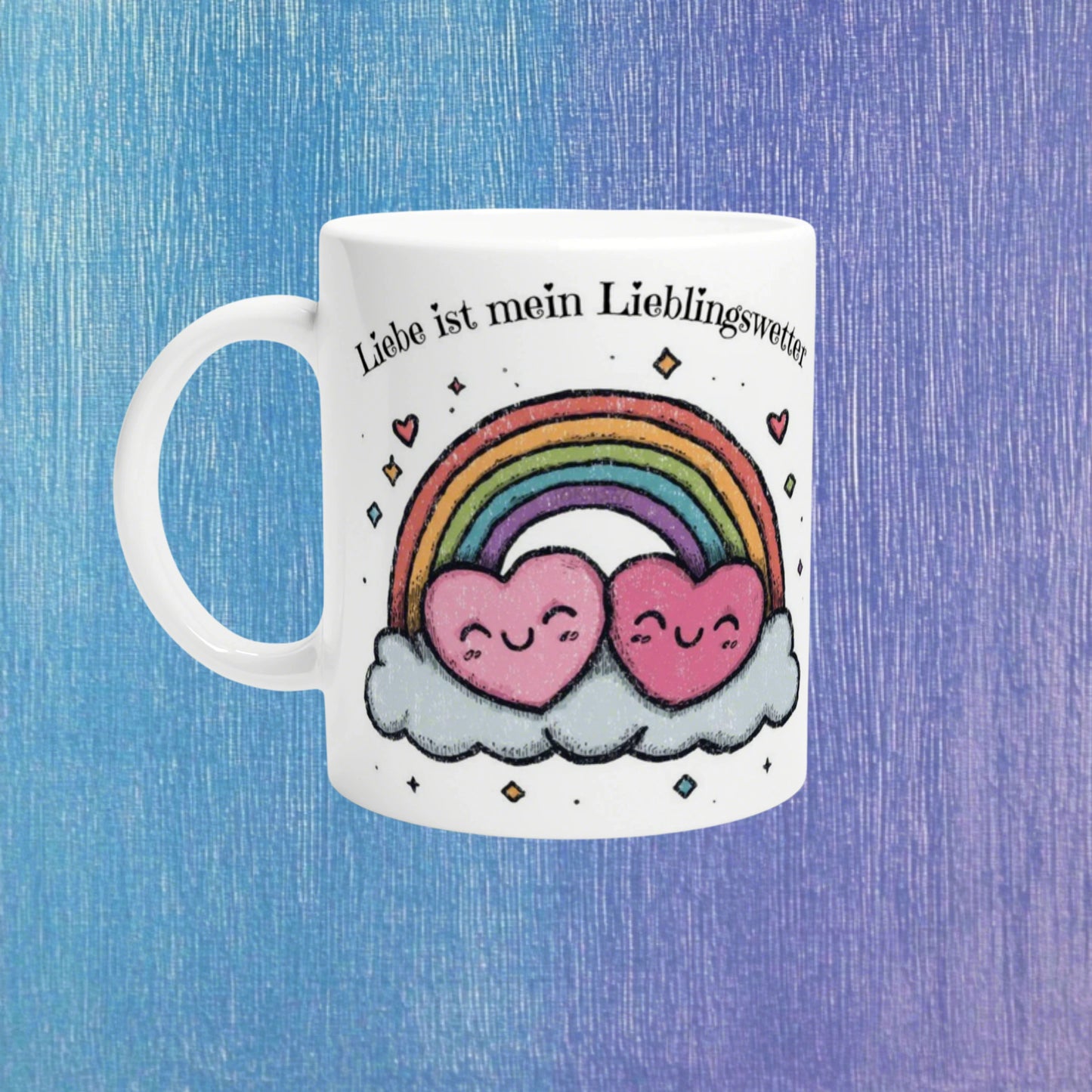 White mug mockup with a rainbow arching over two smiling pink hearts on clouds and the German slogan Liebe ist mein Lieblingswetter.