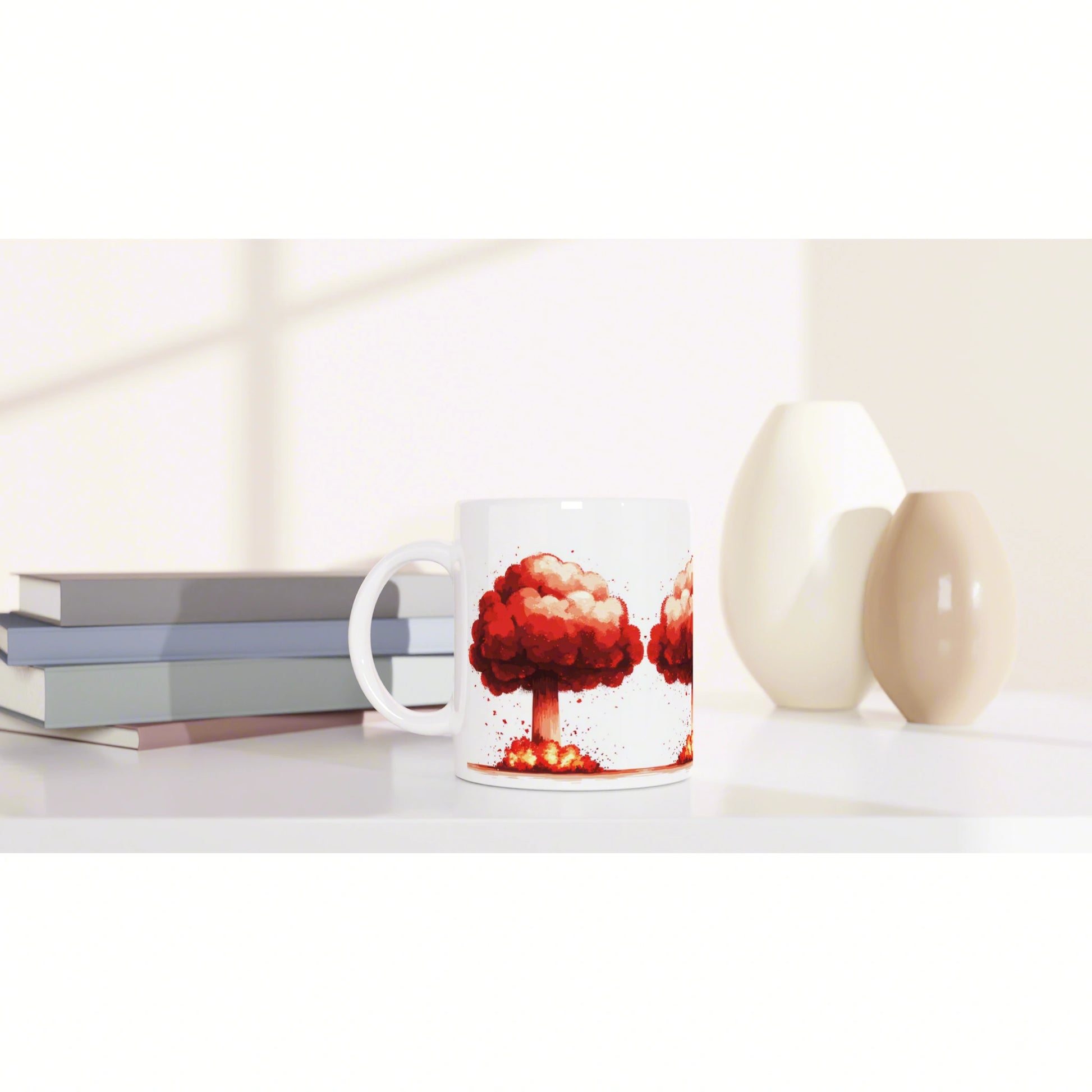 White mug featuring a red tree explosion illustration on a desk with books and beige vases.