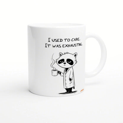 White mug featuring a tired panda in a lab coat, holding a steaming mug with the caption 'I used to care. It was exhausting.'