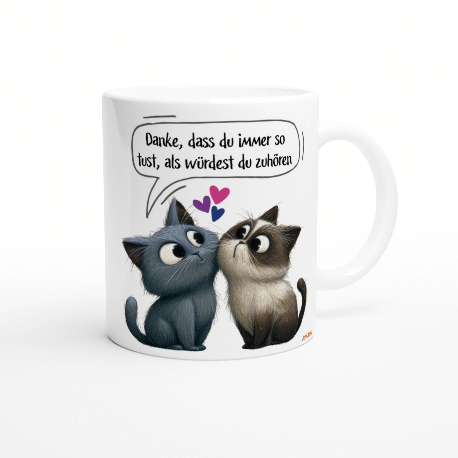 White mug featuring two cartoon cats looking at each other; speech bubble in German about pretending to listen.
