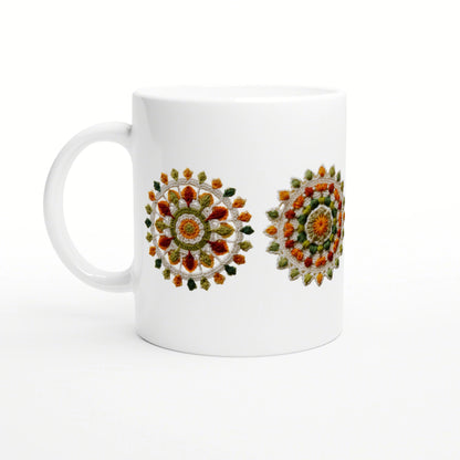 White ceramic mug displaying two colorful circular mandala embroidery motifs on its side.