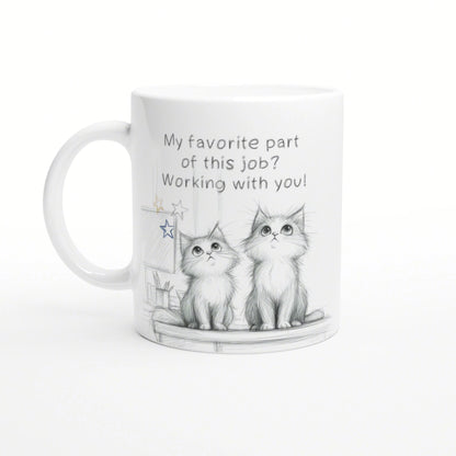 White mug featuring a pencil sketch of two kittens and the slogan 'My favorite part of this job? Working with you!'