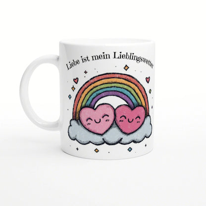 White mug mockup with two pink hearts on a cloud under a rainbow and the German slogan Liebe ist mein Lieblingswetter.