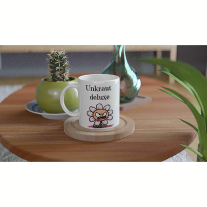 White mug with Unkraut deluxe and a cartoon angry flower, on a wooden table, shown as a product mockup for an online shop.