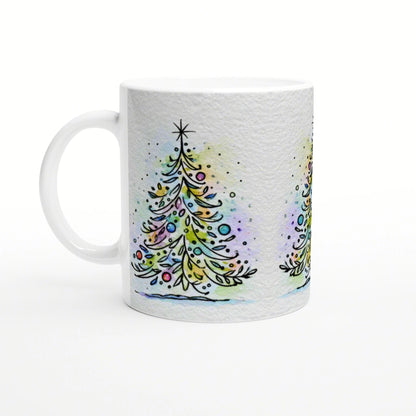 White mug with a wraparound watercolor Christmas tree design and colorful ornaments on a pale background.
