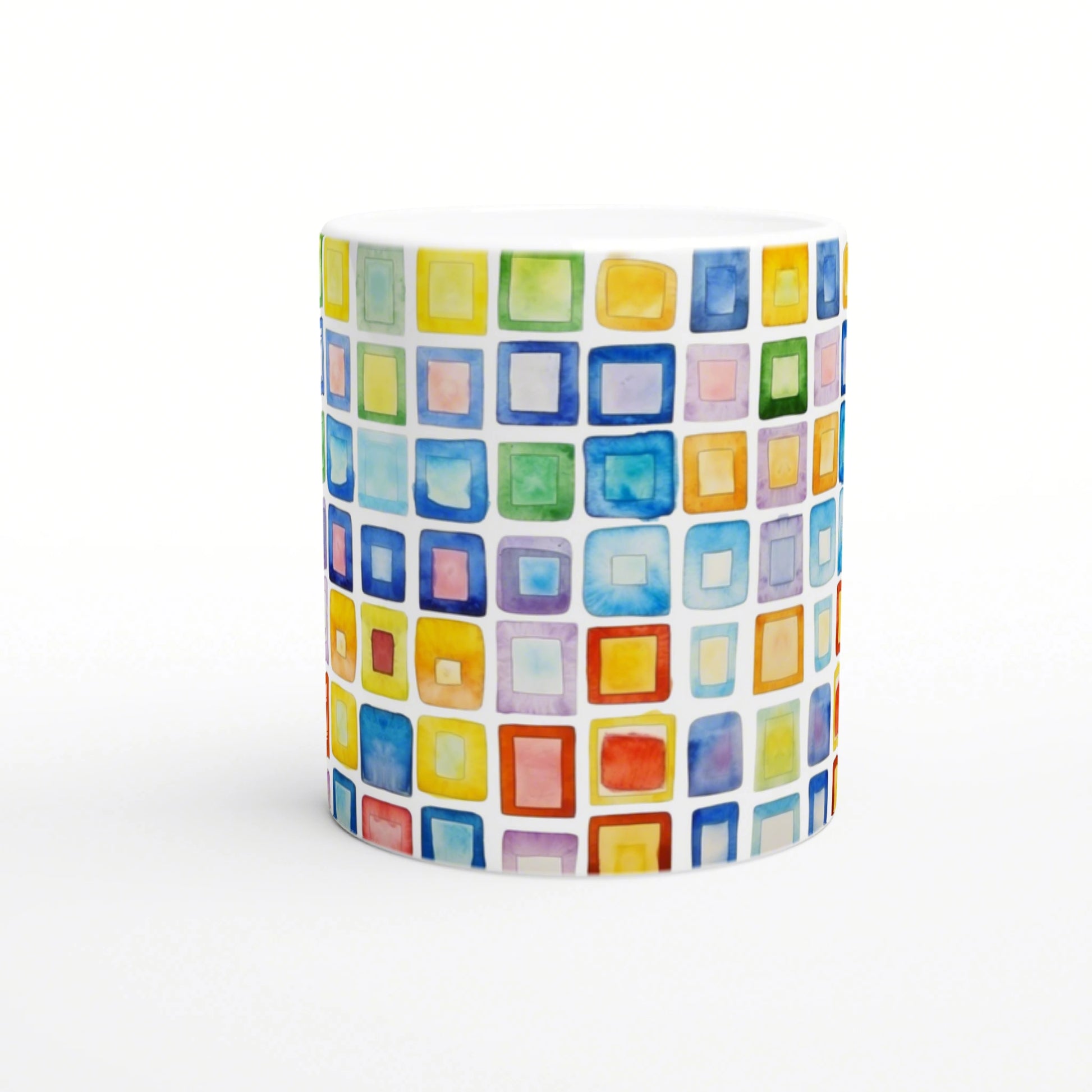 White mug featuring a watercolor mosaic of colorful squares in rainbow hues.