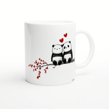White mug with a watercolor illustration of two pandas on a branch, red hearts above.