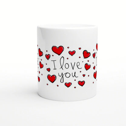 White ceramic mug featuring hand-drawn red hearts and the words I love you in black script.